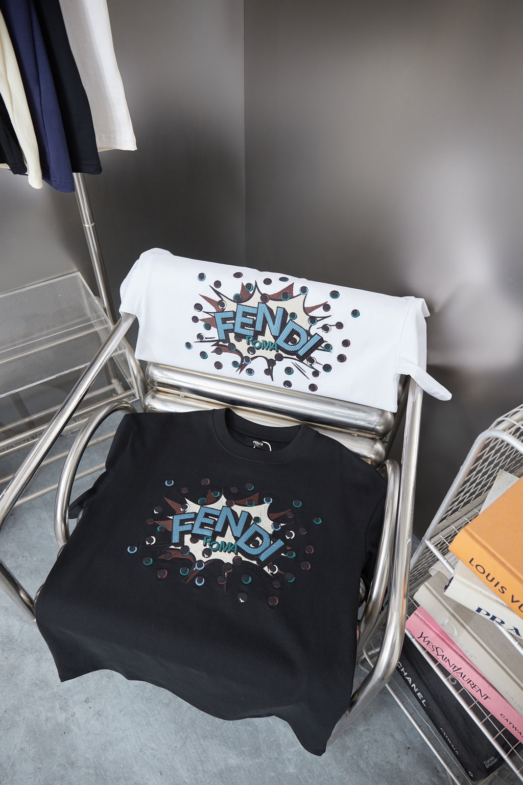 Set of Fendi navy and white T-shirts with colorful FENDI graphics on hangers