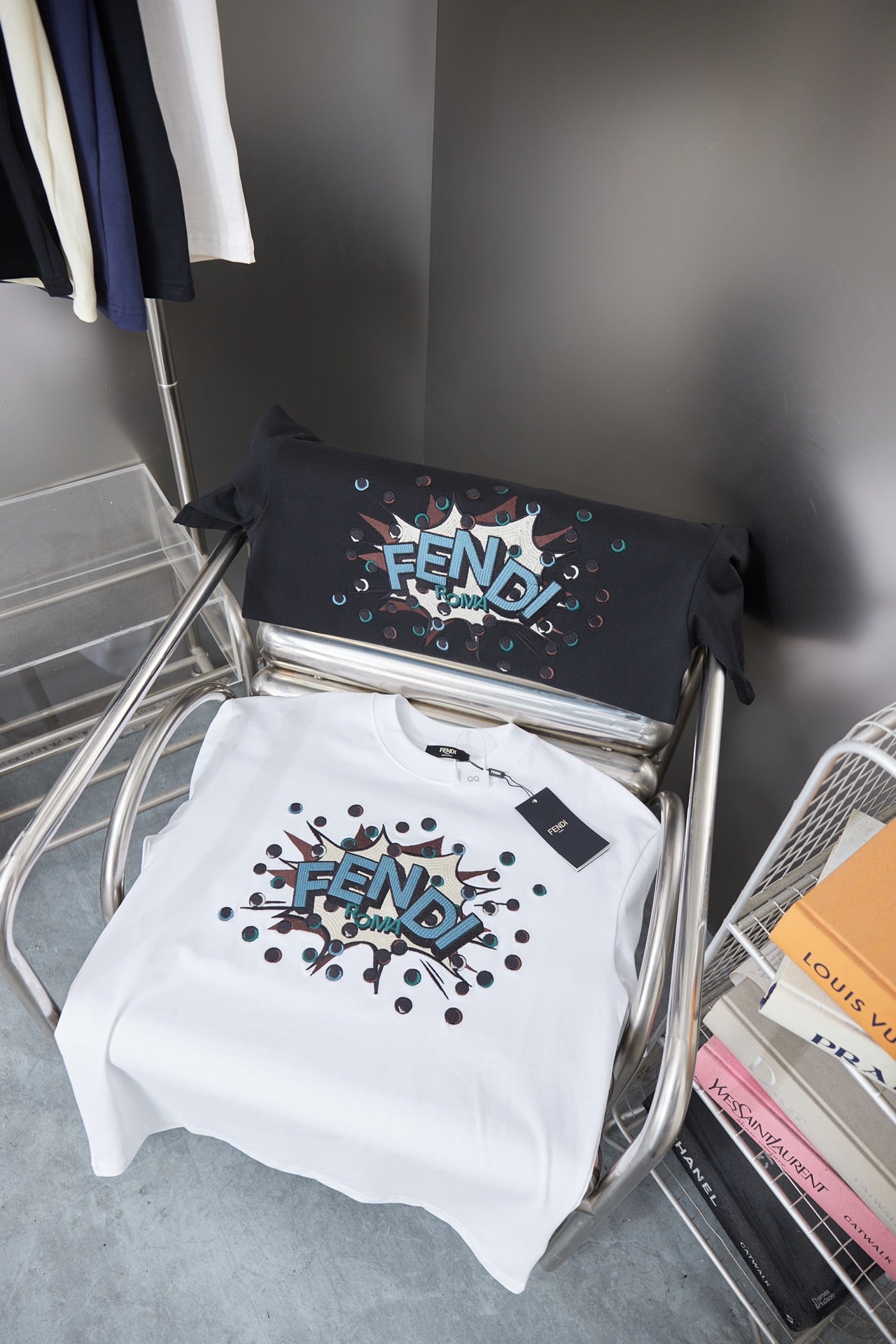 Fendi short-sleeve T-shirts on rack: white and black with colorful logo prints