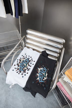 Fendi T-shirts on rack: white and navy each with colorful FENDI confetti logo
