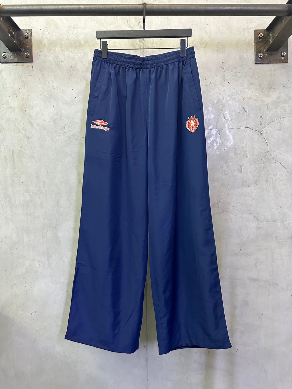 Blue wide-leg drawstring pants with Balenciaga patch on left thigh