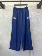 Blue wide-leg drawstring pants with Balenciaga patch on left thigh