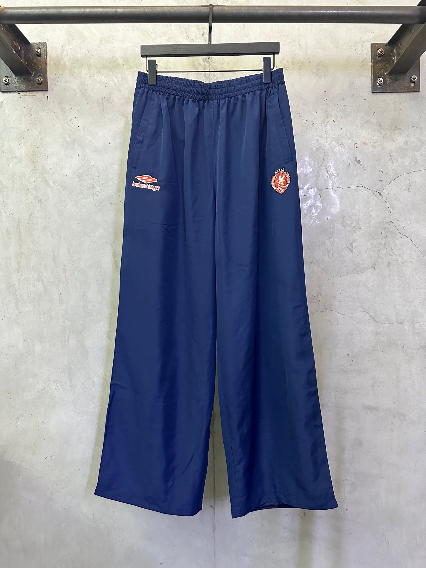 Blue wide-leg drawstring pants with Balenciaga patch on left thigh