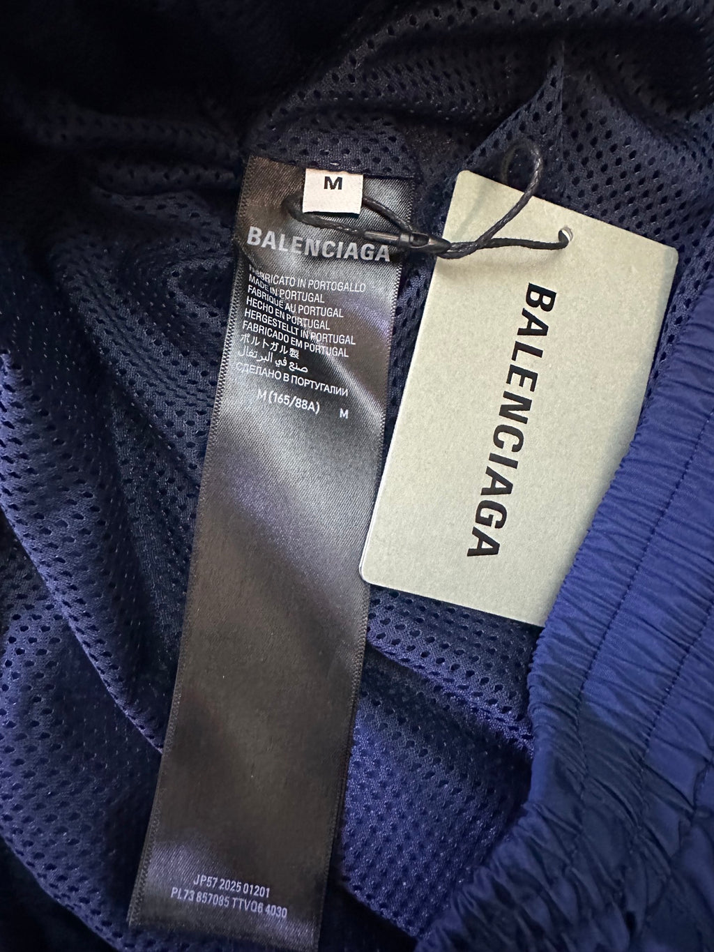 Blue pants with Balenciaga size M tag and care label on inner seam