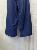 Blue wide-leg drawstring pants with front seam and draped fabric