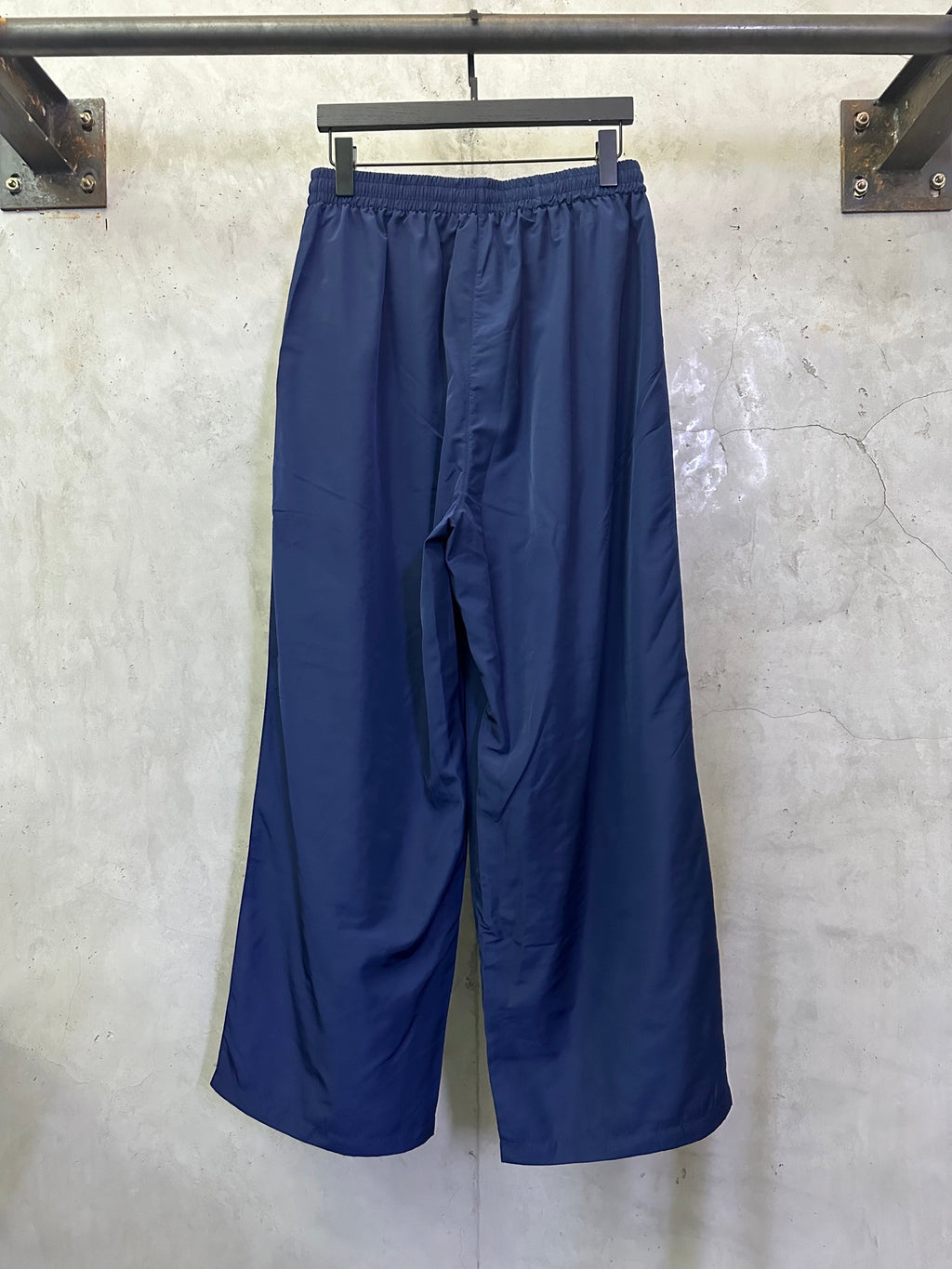 Blue wide-leg drawstring pants, side view with relaxed drape
