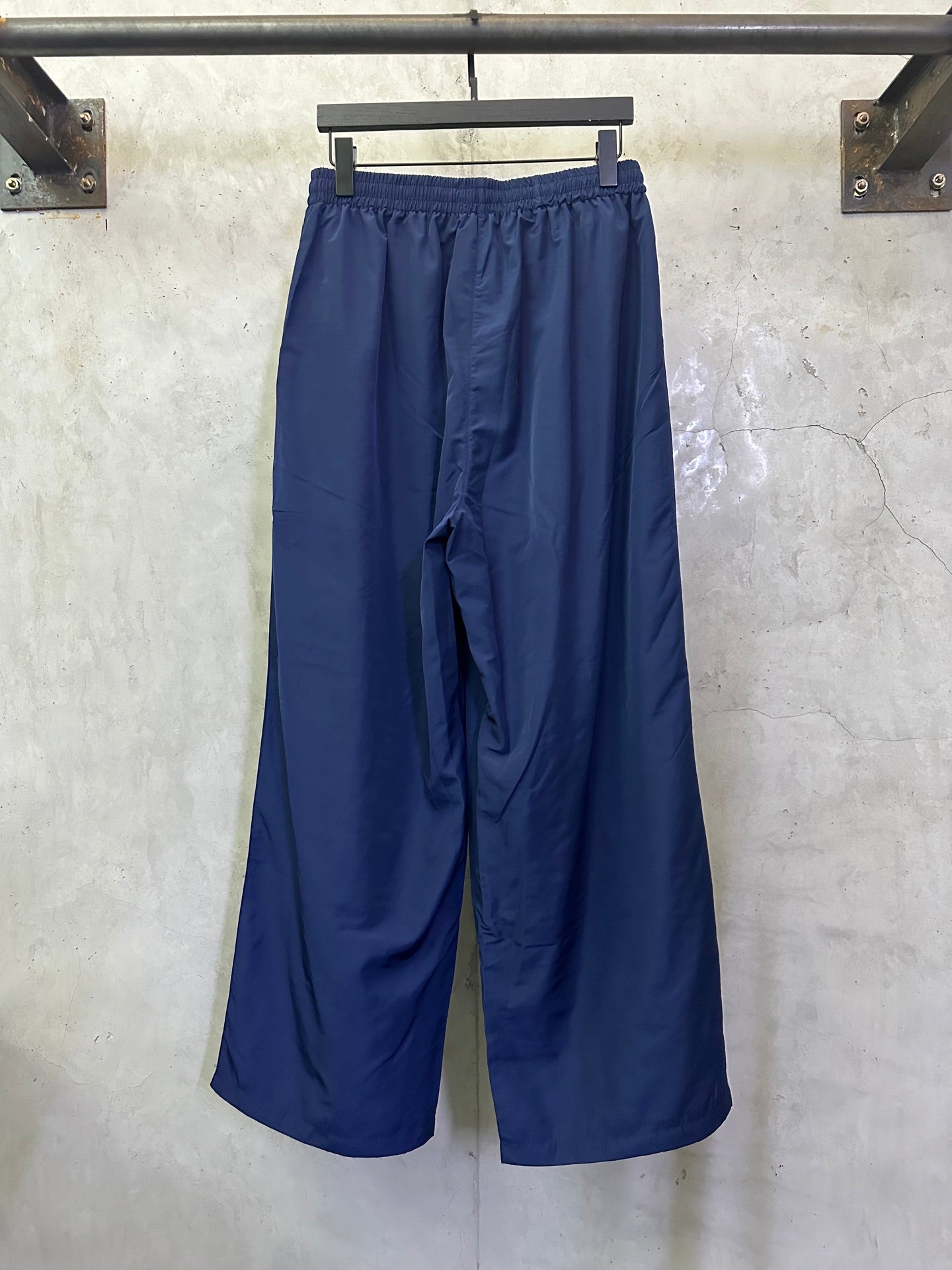 Blue wide-leg drawstring pants, side view with relaxed drape
