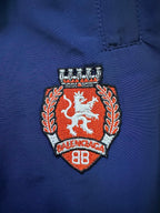 Blue pants with embroidered Balenciaga crest patch on right leg
