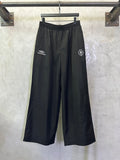 Balenciaga black wide-leg pants with drawstring waist and side logo patches