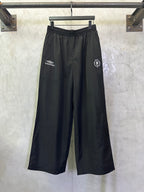Balenciaga black wide-leg pants with drawstring waist and side logo patches