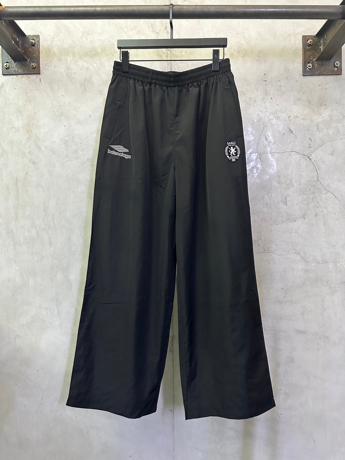 Balenciaga black wide-leg pants with drawstring waist and side logo patches