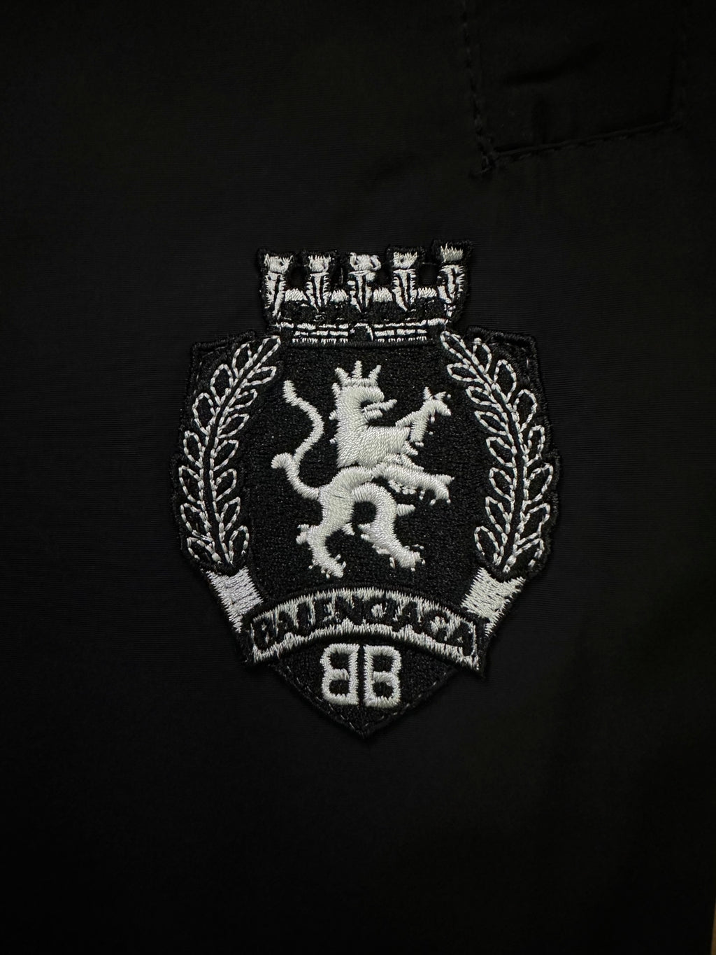Balenciaga black pants with embroidered crest patch on the front