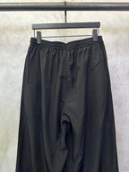 Balenciaga black wide-leg pants with elastic waistband and draped front