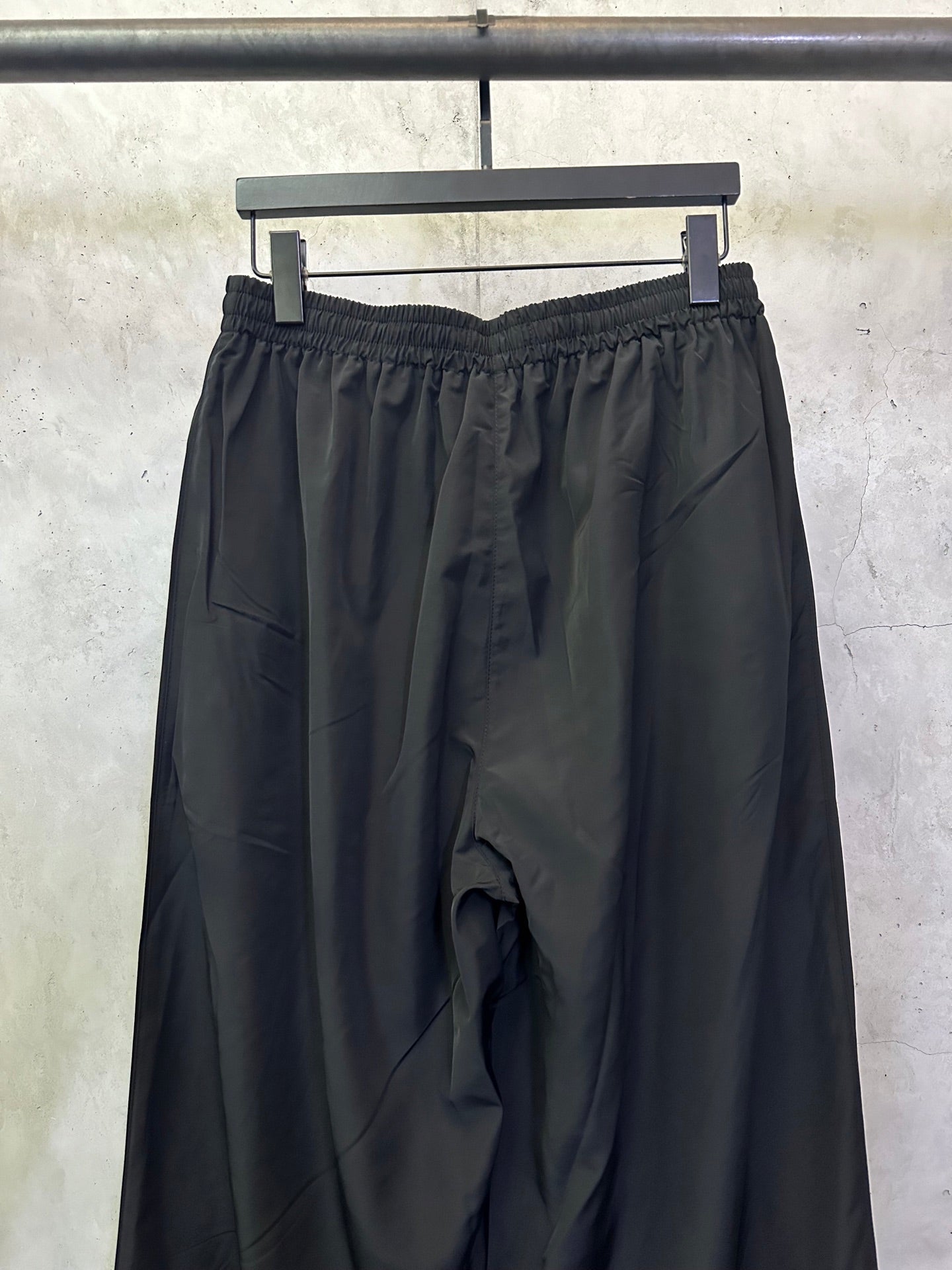 Balenciaga black wide-leg pants with elastic waistband and draped front