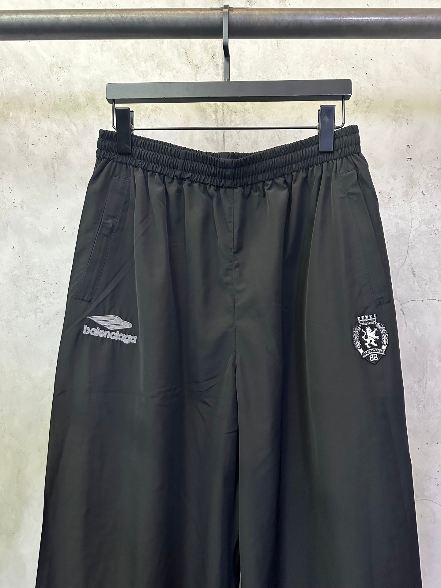 Balenciaga black wide-leg pants with elastic waistband and front side logos