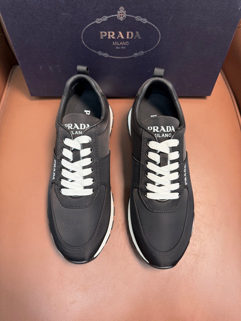 Black Prada leather sneakers, lace-up with white laces and rubber sole