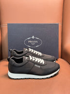 Black Prada sneakers on box, lace-up with white laces and contrasting white sole