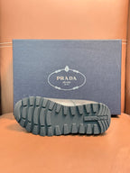 Outsole of dark leather lace-up sneaker with deep tread and brand mark