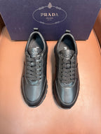 Pair of dark leather lace-up sneakers with rounded toe and low-profile sole