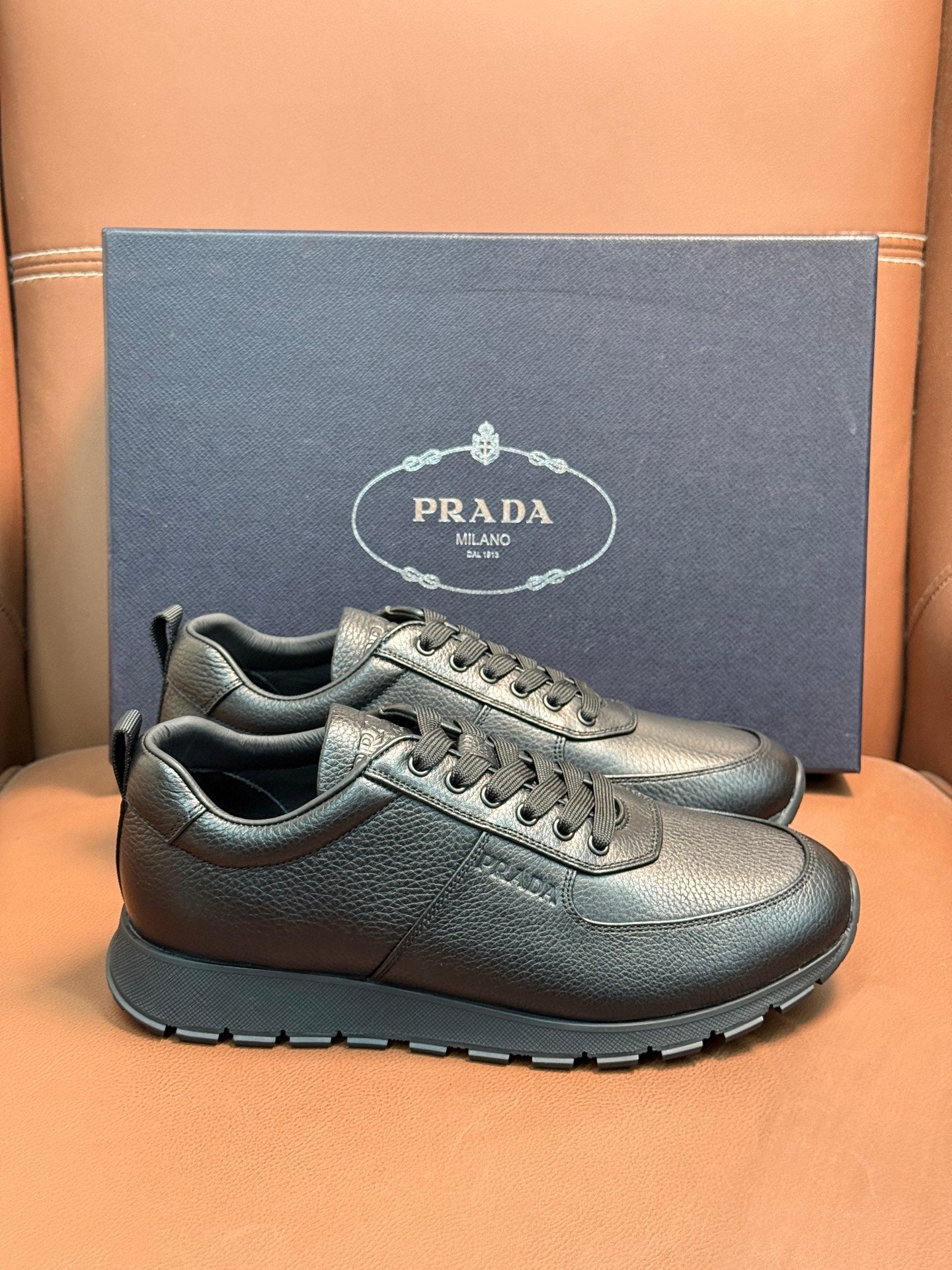 Silver leather lace-up sneakers with chunky black outsole and stitched detail