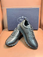 Silver leather lace-up sneakers on a display, showing lace-up and thick sole