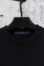 Black crew neck knit sweater on hanger with ribbed collar