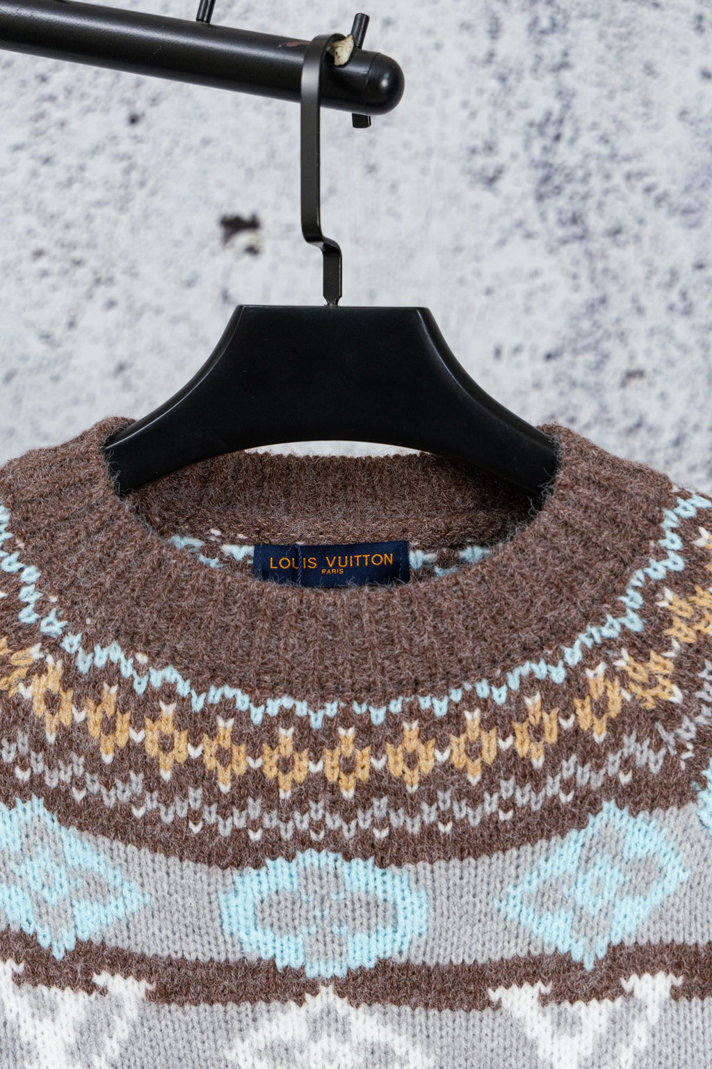 Brown knit sweater neckline with Louis Vuitton neck label