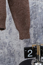 Brown knit sweater sleeve with ribbed cuff detail