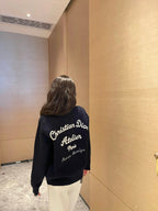 Navy long-sleeve sweatshirt with Christian Dior script and logo on back