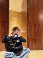 Black long-sleeve sweatshirt with bold Dior-style script graphic on front