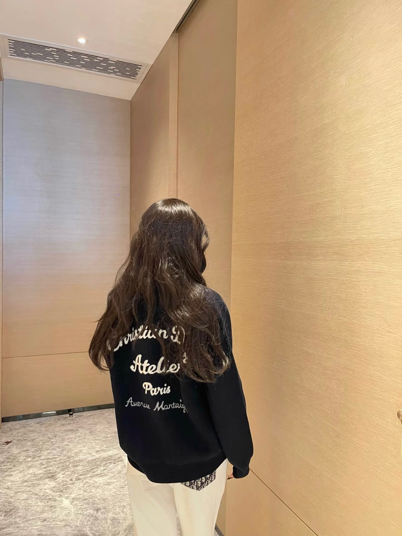 Navy long-sleeve sweatshirt with large back text and logo detail