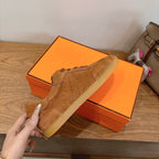 Suede sneakers in tan with lace-up front, perforated toe, and gum-style outsole