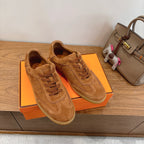 Suede lace-up sneakers in tan, viewed from above with textured panels and stitching