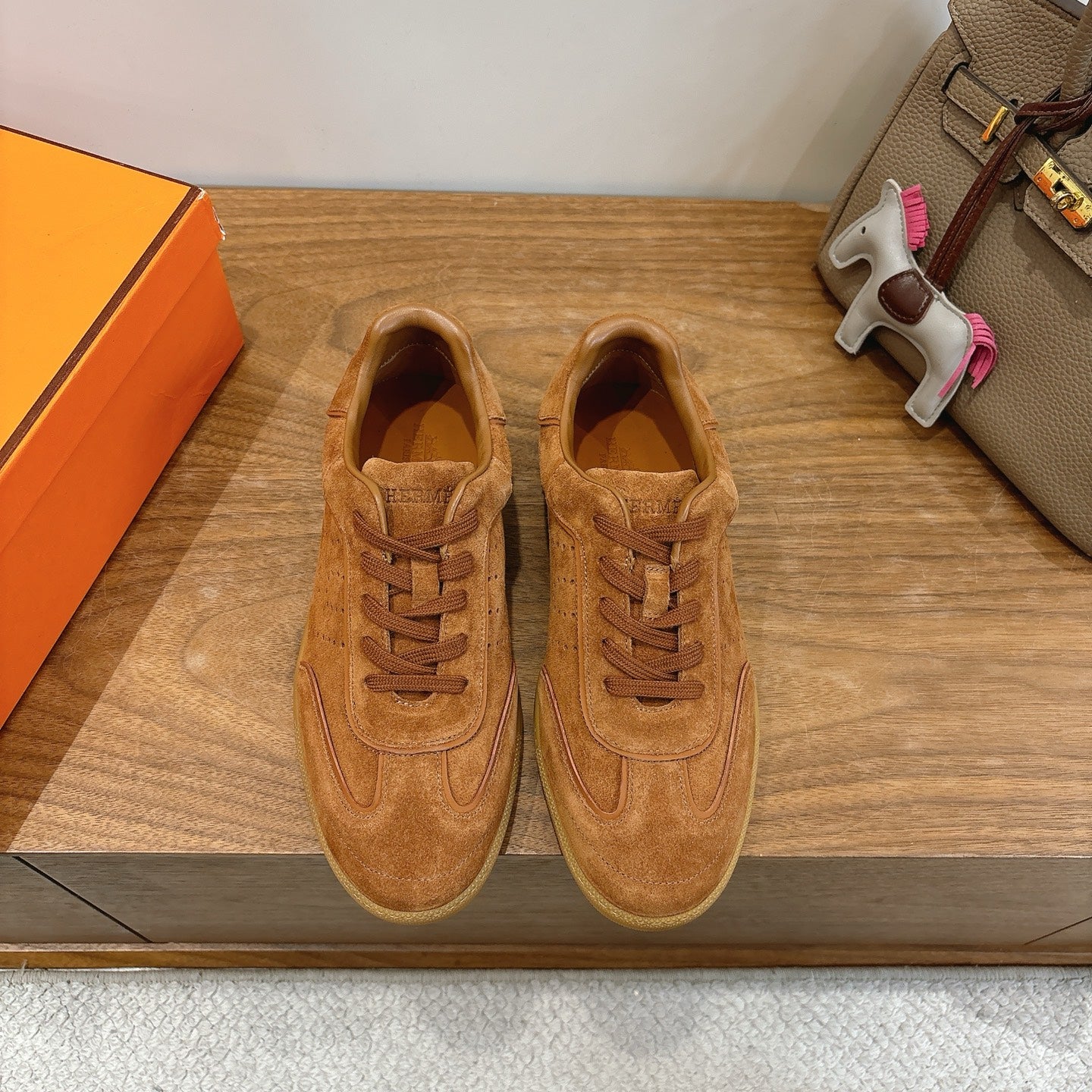 Suede sneakers in tan, lace-up design with perforated toe and classic side swoosh detail
