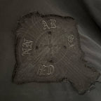 Embroidered square front graphic patch on black long-sleeve shirt