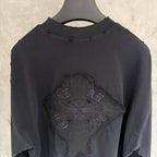 Black long-sleeve crewneck shirt with close-up embroidered front graphic