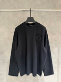 Black long-sleeve crewneck shirt with small chest logo patch