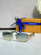Louis Vuitton sunglasses, gold frame with light green tinted lenses and metal hinge detail