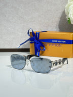 Louis Vuitton sunglasses, light blue tinted lenses with gold frame and chain-link detail