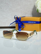 Louis Vuitton sunglasses, gold frame with amber-tinted lenses and metal link detail