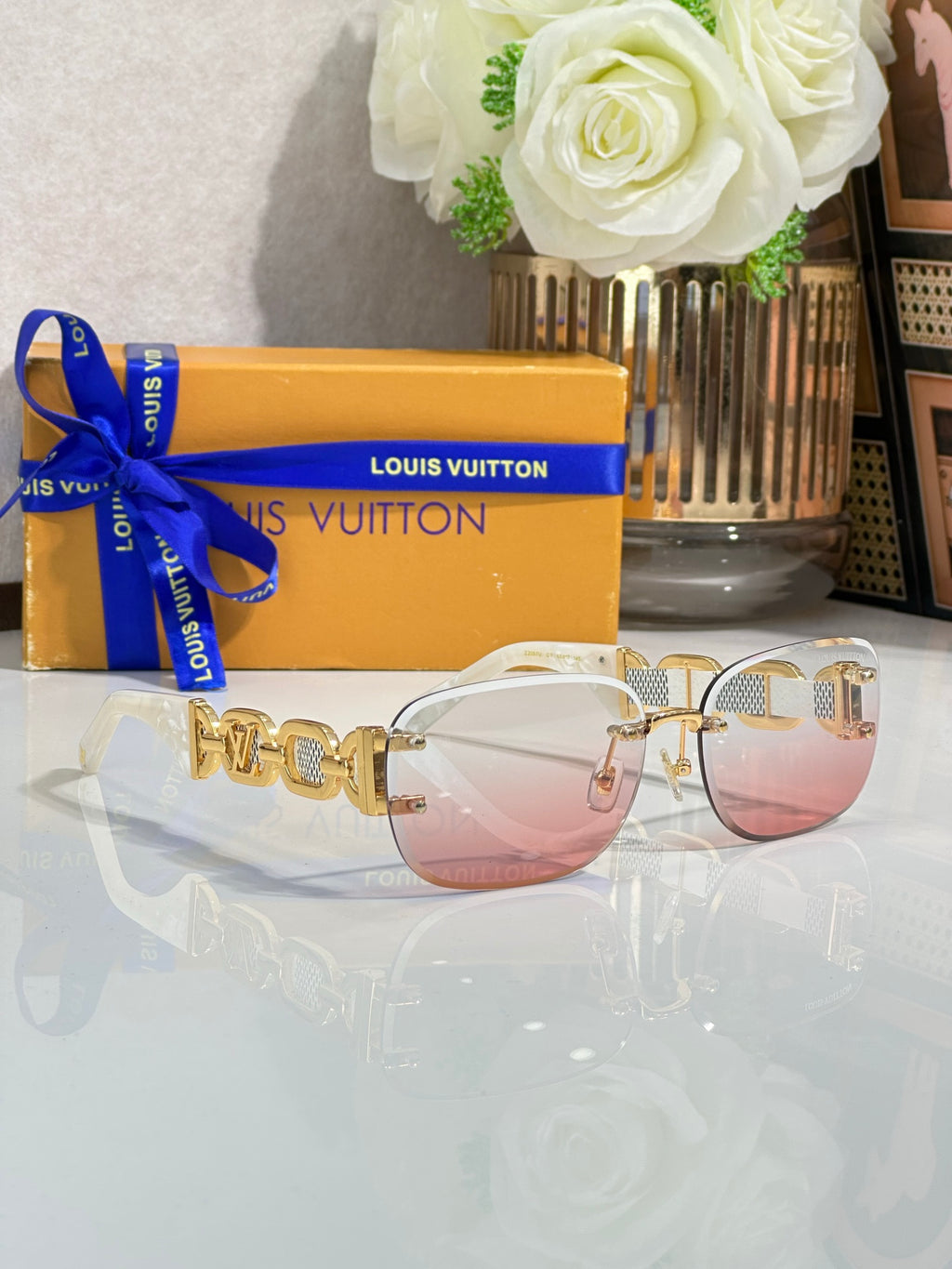 Louis Vuitton sunglasses, gold frame with pale pink tinted lenses and chain-link temples