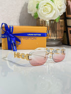 Louis Vuitton sunglasses, gold frame with pale pink tinted lenses and chain-link temples