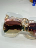 Louis Vuitton sunglasses close-up, gold frame with mirrored brown tinted lenses