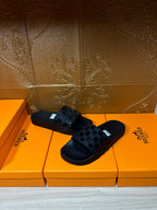 Hermes black slide sandals with square-patterned strap top view