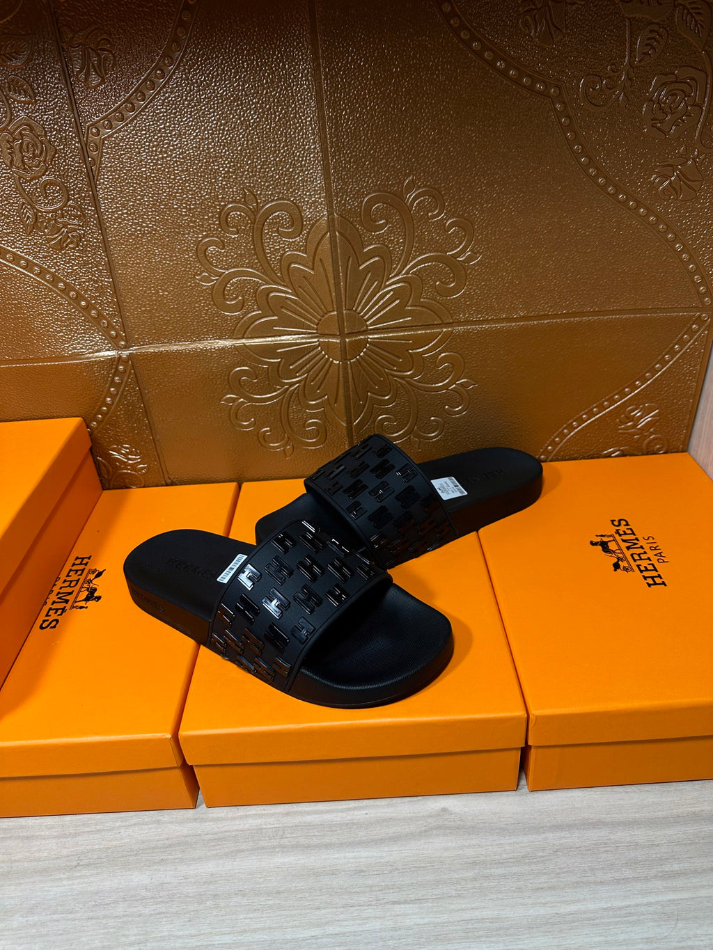 Hermes black slide sandals with studded look strap and white tag