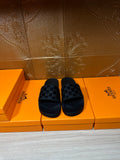 Hermes black slide sandals with patterned strap detail