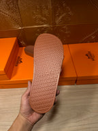 Hermes dark brown slide sandal outsole with embossed H-pattern tread and branding