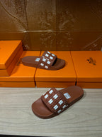 Hermes dark brown slide sandals with strap featuring small H motifs across the top