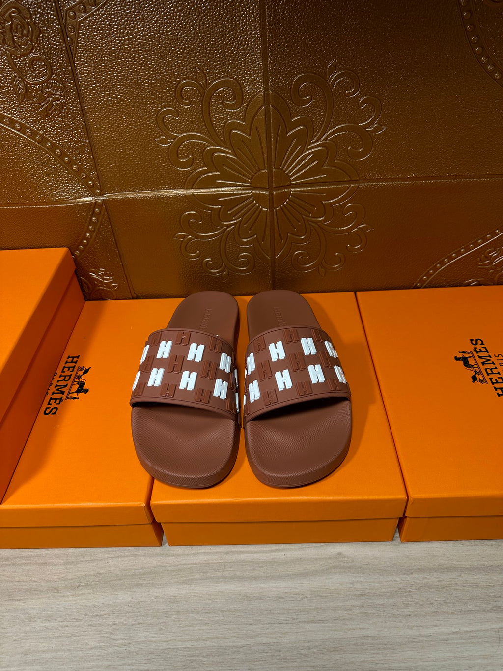 Hermes leather slide sandals in dark brown with patterned strap and open toe