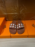 Hermes leather slide sandals in dark brown with patterned strap and open toe