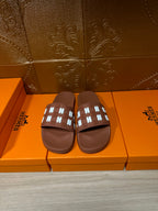 Hermes leather slide sandals in dark brown with patterned strap and open toe